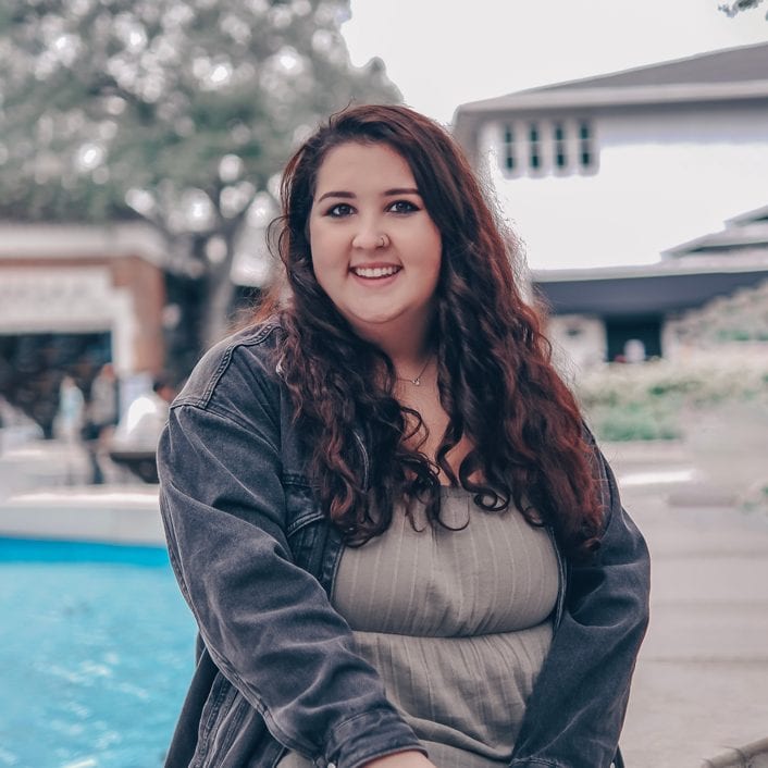 bella-straub-headshot-sitting how to take a professional photo for linkedin in 2021 with beautiful professional woman smiling for camera in hyde park tampa